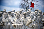 Ksitigarbha Bodhisattva buddhist temple in Bintan, Indonesia - Buddhist umbrella full of 500 statues with expression told of Ksitigarbha Bodhisattvas at the temple in Bintan, Indonesia. Ksitigarbha Bodhisattva is often referred to as the Bodhisattva of the Hell beings because of his vow to not achieve Buddhahood until all the Hells are empty. However, his vow actually encompasses all sentient beings, similar to that of Living Buddha Lien-Shen. He vows to reveal all the secrets of even the hidden teachings, in order to save sentient beings, even if he has to suffer retribution, and the pulveriz