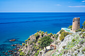 Scenic coastal view featuring a historical tower on cliffs in Andalusia.