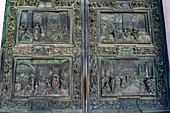 Detail of a main portal door of the Duomo of Pisa. Cast in bronze in 1605 by Giambologna. Pisa, Italy.