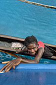 Residents of Tungelo Island in their traditional dugout canoes, New Ireland province, Papua New Guinea