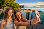 Selfie on the sunset time on the beach grill bar and restaurant of The Ritz-Carlton Langkawi luxury hotel in Langkawi, Malaysia.