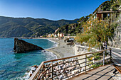 The Fegina beach in off peak season in Monterosso al Mare, Cinque Terre, Italy, with the Scoglio Malpasso or Malpasso Rock.