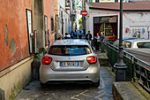 A car negotiating the narrow Via San Nicola in the historic center of Sorrento, Italy.