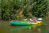 Kayaking in the canal du midi a Trèbes, France. Boat in the Canal du Midi near Carcassonne Aude South of France southern waterway waterways holidaymakers queue for a boat trip on the river, France, Europe