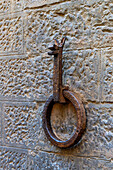 A bronze ring for tying up horses on a wall by the Dante house in Florence, Italy.