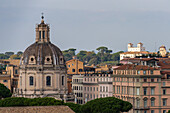 Dome of the Church of the Most Holy Name of Mary at the Trajan Forum in Rome, Italy. The white building behind at right is the Villa Medici.