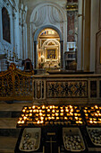 Votive candles & a chapel on the left side of the nave of the Duomo of Amalfi, Amalfi, Italy.