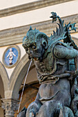 Fountain statue of a sea monster on the Piazza Santissima Annunciata, Florence, Italy. Behind is the Hospital of the Innocents.