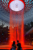 Jewel Changi Airport is a new terminal building under a glass dome, with indoor waterfall and tropical forest, shopping malls and dining, in Singapore