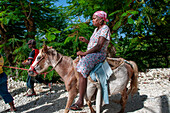 Haiti Voodoo Festival in Saut d'Eau, in Saut d'Eau, Ville Bonheur, Haiti. Thousands of both Vodou and Catholic followers gathered under the Saut d'Eau waterfall in Haiti. The pilgrimage, made by Voodou practitioners and Catholics alike, originated with the sighting of the likeness of the Virgin Mary on a palm leaf close to the falls half a century ago. Catholism and Voodou practices are forever intertwined in its Haitian form. The appearance of a rainbow beneath the falls is said indicate that Danbala - the great lord of the waterfall - and Ayida Wedo - the rainbow - are making love. Fertility