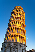 Moon rising by the Leaning Tower of Pisa, the campanile or bell tower of the Duomo or Cathedral of Pisa. Pisa, Italy.