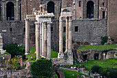 Ruins of the Temple of Saturn (left) & Temple of Vespasian and Titus (right) in the Forum in Rome, Italy. Colosseum Archaeological Park.