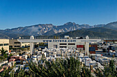 The shipping yard for Tirrena, an international marble shipping company in Carrara, Italy. Behind are the Apuan Alps with the quarries visible.