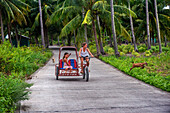 Tourist girls in a bike and tuctuc in Sipaway Island, San Carlos City, Negros Occidental, Philippines