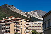 Marble quarries in the Apuan Alps overlooking an apartment building in Carrara, Italy.