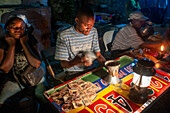 Night in the Haiti Voodoo Festival in Saut d'Eau, in Saut d'Eau, Ville Bonheur, Haiti. Thousands of both Vodou and Catholic followers gathered under the Saut d'Eau waterfall in Haiti. The pilgrimage, made by Voodou practitioners and Catholics alike, originated with the sighting of the likeness of the Virgin Mary on a palm leaf close to the falls half a century ago. Catholism and Voodou practices are forever intertwined in its Haitian form. The appearance of a rainbow beneath the falls is said indicate that Danbala - the great lord of the waterfall - and Ayida Wedo - the rainbow - are making lo