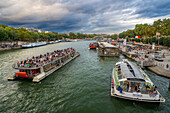 Passenger touristic cruise ship in the Seine river is moored to the pier near Eiffel Tower