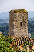 The Torre Campatelli or Campatelli Tower in the medieval city of San Gimignano, Italy. Television antennas sit on rooftops of medieval buildings.