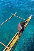 Residents of Tungelo Island in their traditional dugout canoes, New Ireland province, Papua New Guinea