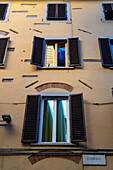 Architectural detail with cutouts in the stucco showing details of the medieval building in Florence, Italy.