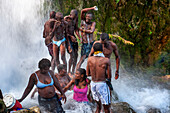 Haiti Voodoo Festival in Saut d'Eau, in Saut d'Eau, Ville Bonheur, Haiti. Thousands of both Vodou and Catholic followers gathered under the Saut d'Eau waterfall in Haiti. The pilgrimage, made by Voodou practitioners and Catholics alike, originated with the sighting of the likeness of the Virgin Mary on a palm leaf close to the falls half a century ago. Catholism and Voodou practices are forever intertwined in its Haitian form. The appearance of a rainbow beneath the falls is said indicate that Danbala - the great lord of the waterfall - and Ayida Wedo - the rainbow - are making love. Fertility