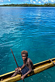 Residents of Tungelo Island in their traditional dugout canoes, New Ireland province, Papua New Guinea