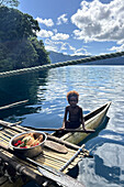 Residents of Vitu Islands in their traditional dugout canoes, Garove Island, Johann Albrecht Harbour, Papua New Guinea