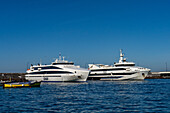 Two high-speed passenger ferries docked in the harbor at Marina Grande on the island of Capri, Italy.