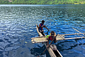 Residents of Vitu Islands in their traditional dugout canoes, Garove Island, Johann Albrecht Harbour, Papua New Guinea