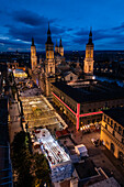 Aerial view of the Cathedral Basilica of of Our Lady of the Pillar and El Pilar square illuminated at night during Christmas, Zaragoza, Spain