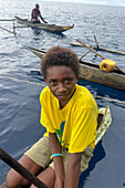 Residents of New Hanover island in their traditional dugout canoes, New Ireland province, Papua New Guinea