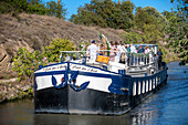 Wedding on the deck of a ship. Canal du Midi at Le Somail Aude South of France southern waterway waterways holidaymakers queue for a boat trip on the river, France, Europe