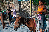 Haiti Voodoo Festival in Saut d'Eau, in Saut d'Eau, Ville Bonheur, Haiti. Thousands of both Vodou and Catholic followers gathered under the Saut d'Eau waterfall in Haiti. The pilgrimage, made by Voodou practitioners and Catholics alike, originated with the sighting of the likeness of the Virgin Mary on a palm leaf close to the falls half a century ago. Catholism and Voodou practices are forever intertwined in its Haitian form. The appearance of a rainbow beneath the falls is said indicate that Danbala - the great lord of the waterfall - and Ayida Wedo - the rainbow - are making love. Fertility