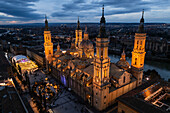 Aerial view of the Cathedral Basilica of of Our Lady of the Pillar and El Pilar square illuminated at night during Christmas, Zaragoza, Spain