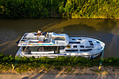 Aerial view of Canal du Midi at Argens Minervois-lock South of France southern waterway waterways holidaymakers queue for a boat trip on the river, France, Europe