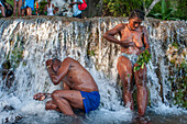 Haiti Voodoo Festival in Saut d'Eau, in Saut d'Eau, Ville Bonheur, Haiti. Thousands of both Vodou and Catholic followers gathered under the Saut d'Eau waterfall in Haiti. The pilgrimage, made by Voodou practitioners and Catholics alike, originated with the sighting of the likeness of the Virgin Mary on a palm leaf close to the falls half a century ago. Catholism and Voodou practices are forever intertwined in its Haitian form. The appearance of a rainbow beneath the falls is said indicate that Danbala - the great lord of the waterfall - and Ayida Wedo - the rainbow - are making love. Fertility