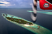 Maldives seaplane flying above islands