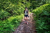 Girl running on the way to the San Adrián tunnel on the Aizkorri mountain range at the Basque Country, Goierri, Basque Highlands Basque Country, Euskadi Spain.