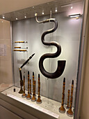 A collection of antique woodwind instruments in the Accademia Gallery in Florence, Italy. Shown are a large serpent, a basset-horn, piccolos and several clarinets.