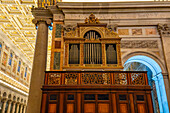 An ornate antique pipe organ in the transept of the Basilica of St. Paul Outside the Walls, Rome, Italy.