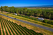 Aerial view of a boats in the Canal du Midi near Carcassonne Aude South of France southern waterway waterways holidaymakers queue for a boat trip on the river, France, Europe