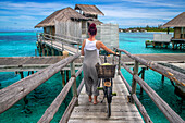 Ride a bicycle in luxury water villas of Six Senses Laamu maldives luxury resort villas, Laamu Atoll region Maldives