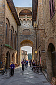 The Via San Giovanna passes through the Porta San Giovanni into the medieval city of San Gimignano, Italy.