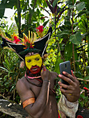 The Huli Wigmen of Papua New Guinea applying make up, Highlands Region