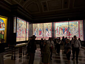 Visitors view the Acts of the Apostles tapestries in the Pinacoteca, Vatican Museums, Vatican City, Rome, Italy.