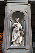 A statue of Dante Alllighieri on the Uffizi Gallery in Florence, Italy.