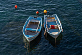 Two small rowboats moored in the harbor in Riomaggiore, Cinque Terre, Italy.