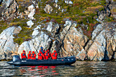 Tourists exploring the Thryms Glacier in zodiac, Skjoldungen Fjord, Southeast coast, Greenland