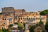 View of the Colosseum and Arch of Titus from Palatine Hill in Rome, Italy.