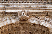 Detail of the Arch of Titus in the Roman Forum in the Colosseum Archaeological Park, Rome, Italy.